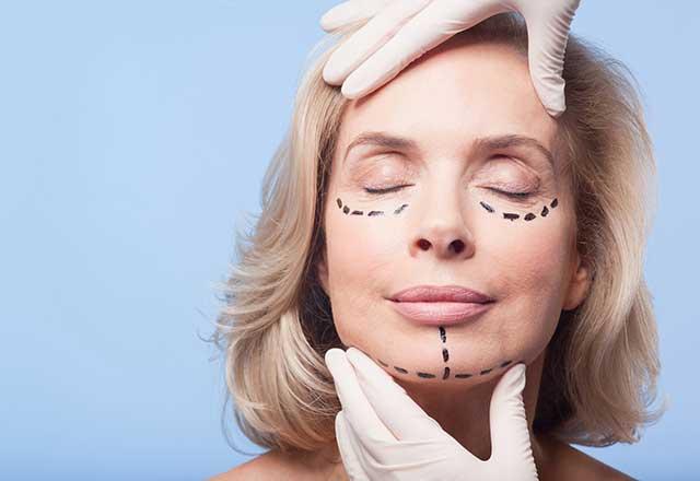 woman getting checked by facial plastic surgeon
